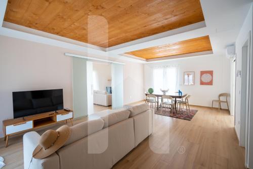 a living room with a couch and a tv at Homiday - Villa Sofia in Atri