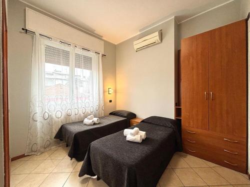 a room with two beds and a window at Residence Oasi Di Monza in Monza