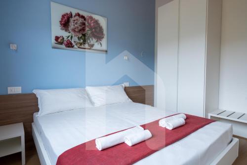 a bedroom with a white bed with two towels on it at Homiday - Villa Sofia in Atri