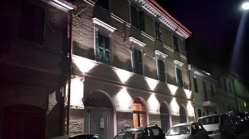 a building with lights on the side of it at night at MONOLOCALI DA VINCI in Falconara Marittima