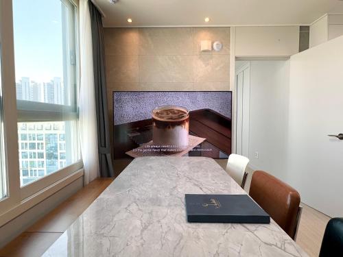 a dining room with a table with a cake on it at Eunhasu D&M Residence in Daejeon