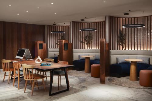 a lobby with a table and chairs and a couch at Courtyard by Marriott Casablanca Downtown in Casablanca