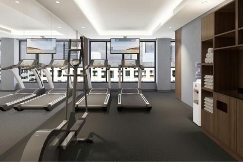 a gym with several treadmills in a room with windows at Courtyard by Marriott Casablanca Downtown in Casablanca