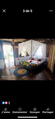 a poster of a bedroom with a bed in a tent at L hippocampe in Maroantsetra Airport