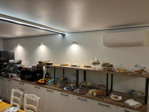 a kitchen with a counter with many plates of food at Ca' Ross in Formigine