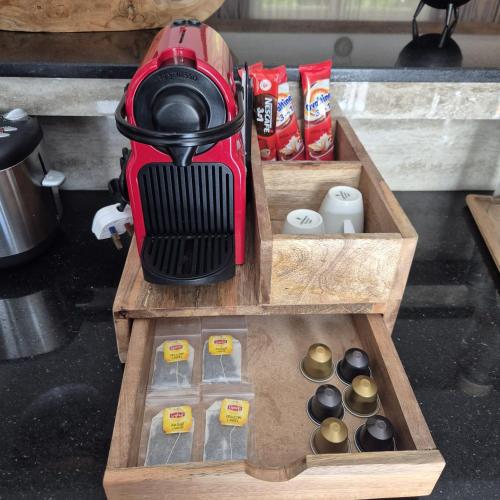 a coffee maker sitting on top of a wooden tray at Treasure Villa in Anse Possession