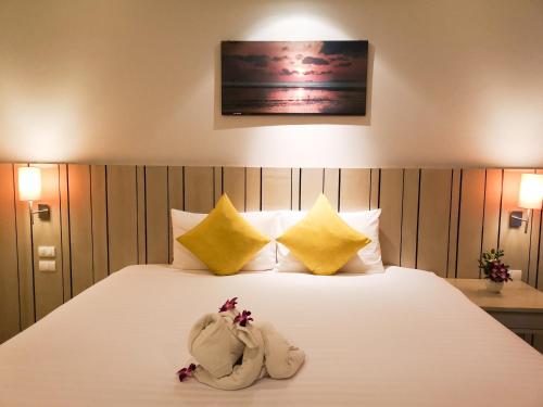 a bedroom with a bed with towels on it at Andakira Hotel - SHA Extra Plus in Patong Beach