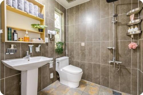 a bathroom with a toilet and a sink and a shower at All in one Guesthouse in Incheon