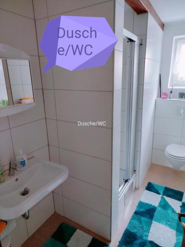 a bathroom with a sink and a toilet at FeWo Schätzer - Geiger in Bodensdorf