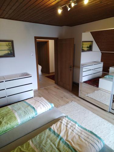 a bedroom with a bed and a large mirror at FeWo Schätzer - Geiger in Bodensdorf