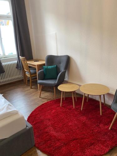 a living room with two tables and a chair at Gasthaus zum Lamm in Ettenheim