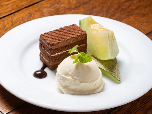 a plate of food with chocolate cake and ice cream at Gasthof Ami in Nikko