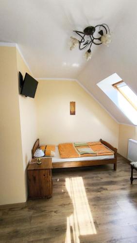a bedroom with a bed and a skylight at Jaś i Małgosia nad Jeziorem Wigry in Rosochaty Róg