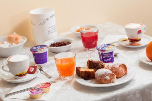 a table with breakfast foods and drinks on it at Hotel Luca in Valverde
