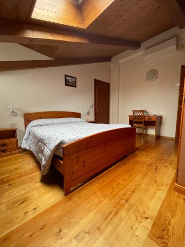 a bedroom with a large bed in a room with wooden floors at Agriturismo Ae Noseare in Torri di Quartesolo