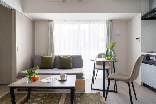 a living room with a couch and a table at Reve Asakusa in Tokyo
