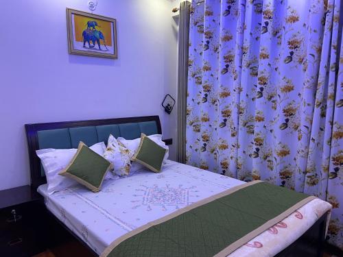 a small bedroom with a bed with purple curtains at The Blessings in Bhowāli