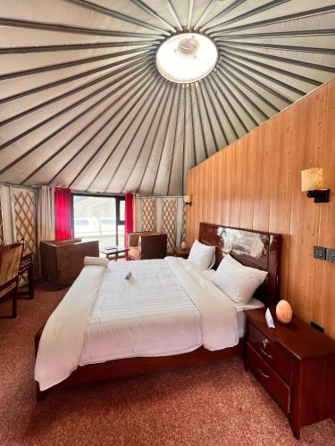 a bedroom with a large bed in a tent at Apex Hotels and Resorts Hussaini in Hunza