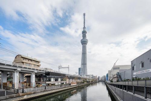a view of a river with a tower in the background at Reve Asakusa in Tokyo