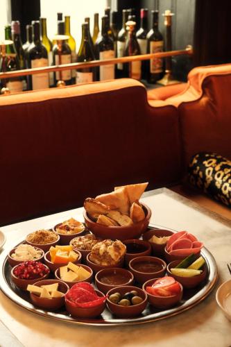 a tray filled with different types of food on a table at Communal Hotel Kutaisi in Kutaisi