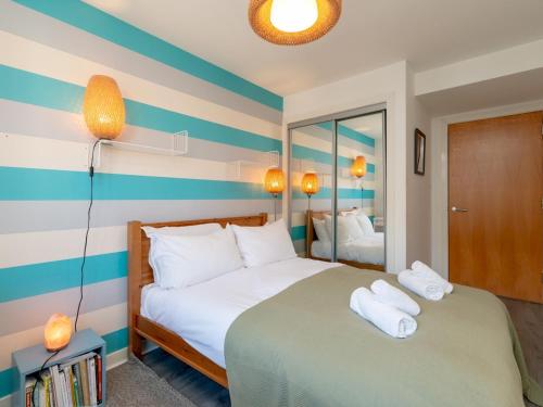 a bedroom with two beds with towels on them at Modern 2-Bdr Flat in Edinburgh - Pass the Keys in Edinburgh