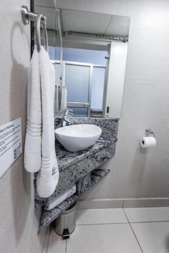 a bathroom with a sink and towels on a counter at Hotel 247 @ White River in White River