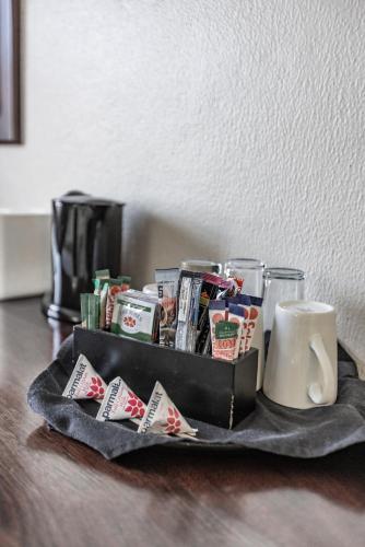 a tray filled with cards and a coffee mug at Hotel 247 @ White River in White River