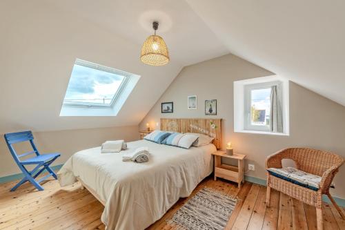 a bedroom with a bed and a chair and a window at Ty Line - Plage à 300 m 1 500 m² de jardin in Lampaul-Plouarzel