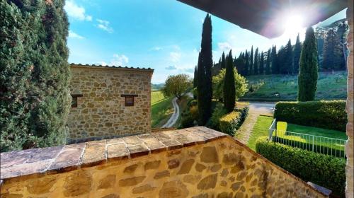 a view of a building in a garden with trees at Il Castellaro Country House in Perugia