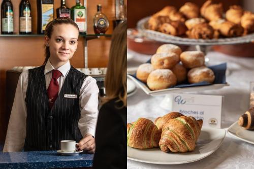 a woman sitting at a table with a plate of bread at Welcome Hotel in Legnano