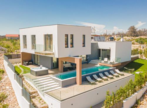 an aerial view of a house with a swimming pool at Villa Šimun Zaton in Zaton