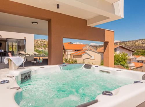 a hot tub in the middle of a house at Villa Šimun Zaton in Zaton