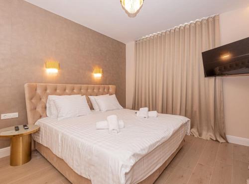 a bedroom with a large bed with two towels on it at Villa Šimun Zaton in Zaton