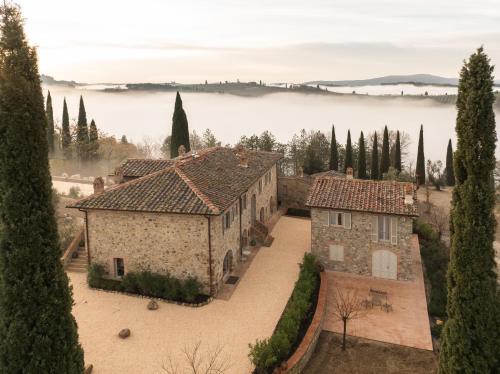 an aerial view of an italian villa with a lake at One Belvedere Tuscany in Poggibonsi