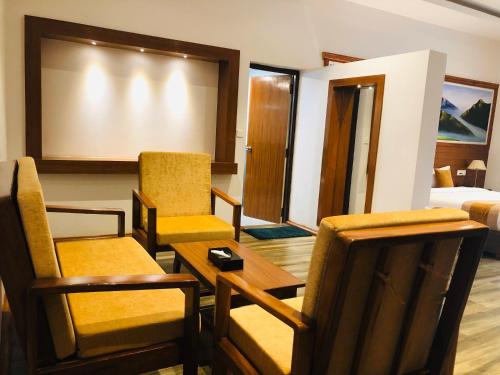 a room with chairs and a table and a projection screen at Manigram Bishram Batika Pvt Ltd in Bhairahawa