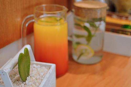 a glass of orange juice and a bowl of rice and a drink at Acropol Hotel in Athens