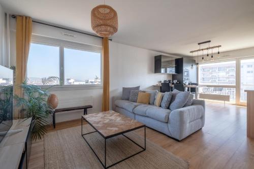 un salon avec un canapé et une table dans l'établissement Appartement Mi-Luna - Welkeys, à Tassin-la-Demi-Lune