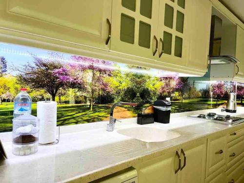 a kitchen counter with a sink and a window at AyVilla 1 garden floor with garden use, sea view in Ayvalık