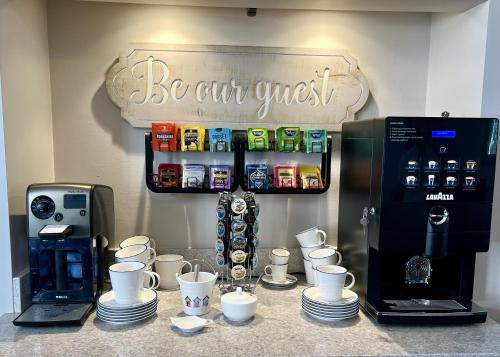 a counter top with cups and a coffee maker at Harbour House in Weymouth