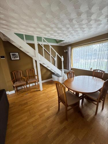 a dining room with a table and chairs at Springfield oaks cottage in Newport
