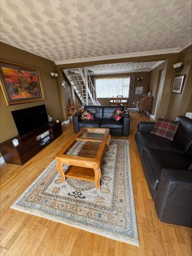 a living room with a couch and a coffee table at Springfield oaks cottage in Newport