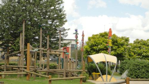 a playground in a park with a wooden play structure at Modern Flat near Central London! in London