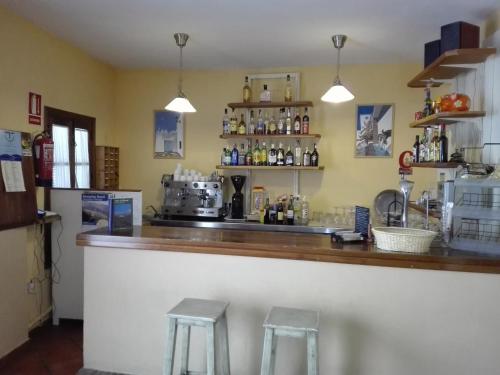 a bar with two stools in front of it at La Posada del Recovero in Genalguacil