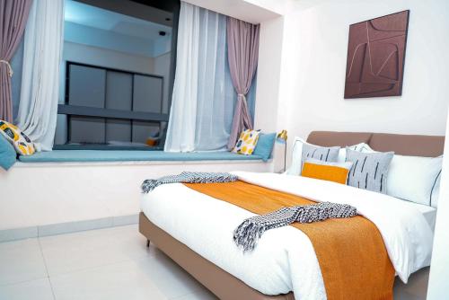 a bedroom with two beds and a window at Greenland Apartment by Link in Kigali