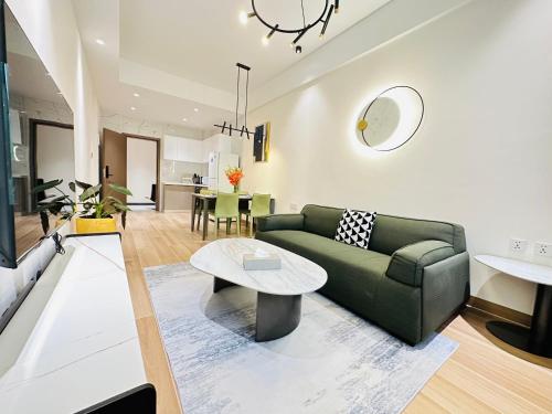 a living room with a green couch and a table at Greenland Apartment by Link in Kigali