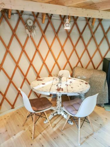 a table and chairs in a yurt at Biały Las Jurta in Starzyna