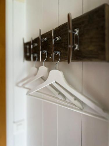 a row of hangers on a wall in a bathroom at Beachhouse 16 Brienzersee in Brienz