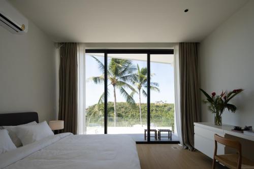 a bedroom with a white bed and a large window at Luxury Private Villa Resort -KW in Nathon Bay