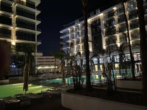 a pool in front of a building at night at Sea Breeze, Lighthouse 4 in Nardaran