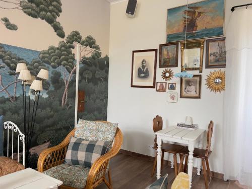 un salon avec un tableau sur le mur dans l'établissement Maison d'hôtes Ojigi - Ancienne école de Trégranteur, à Guégon